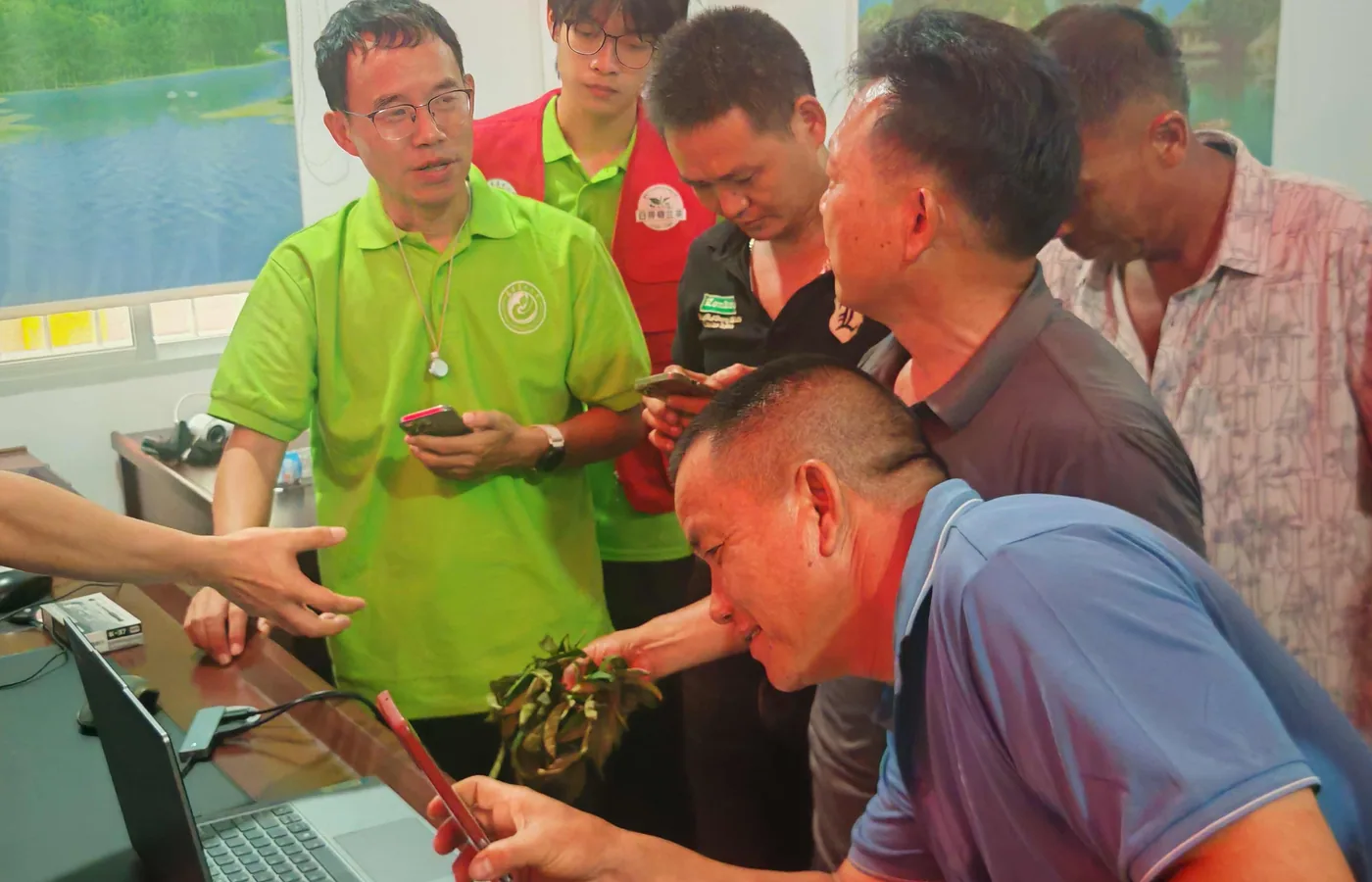 Tea enterprise technicians, growers and field team members in a training discussion